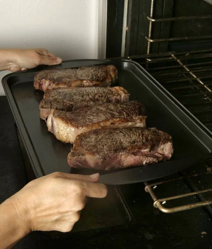 Finishing New York strip steaks in the oven. #grillingsteak