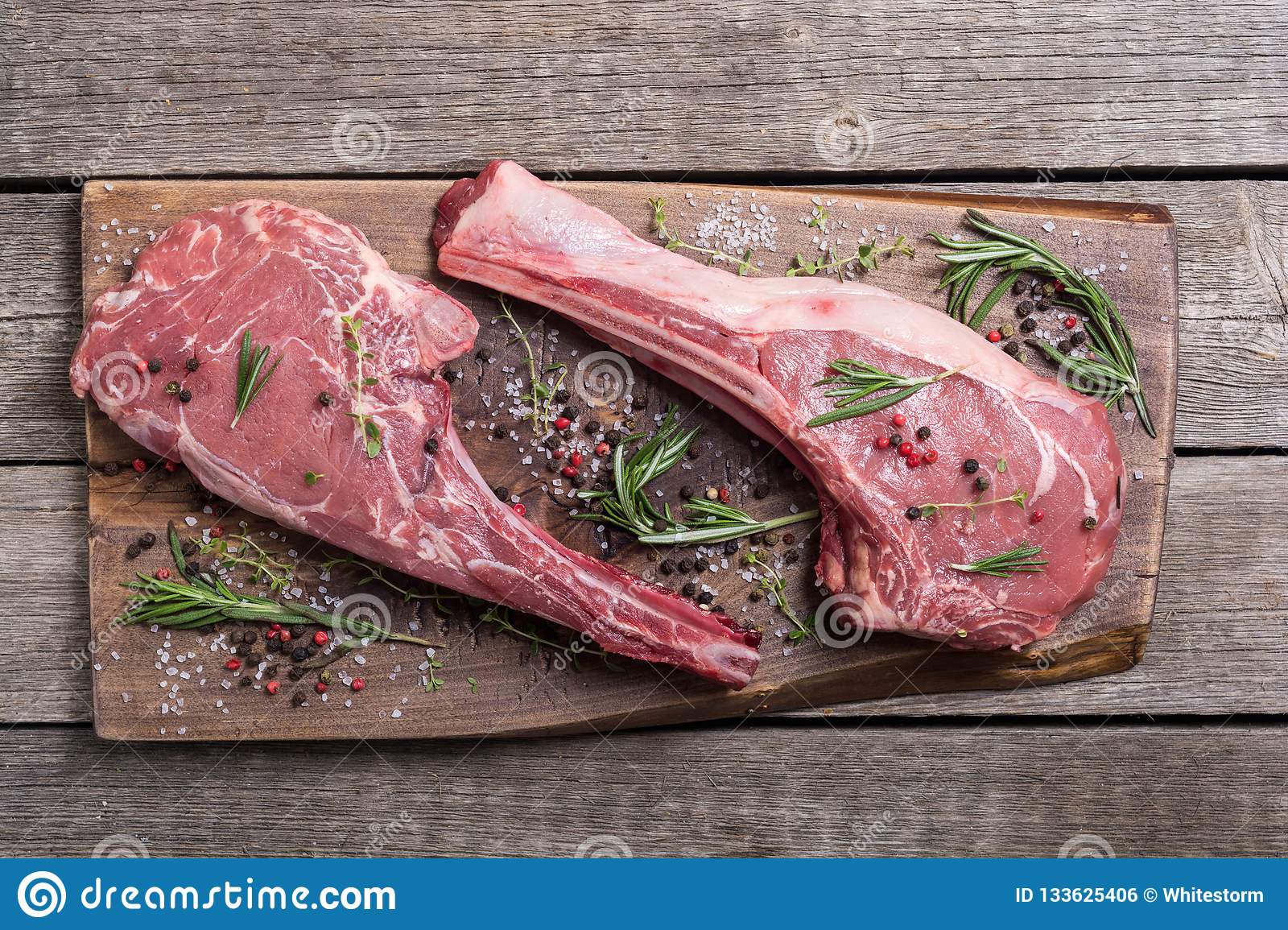 Raw beef tomahawk steak stock photo. Image of garlic ...