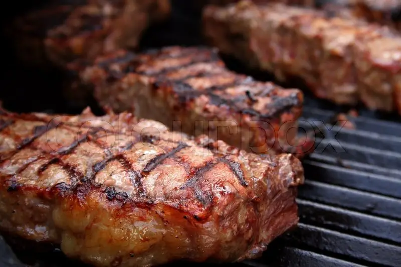 Thick, juicy steaks on a barbecue ...